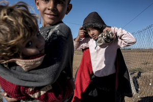 Syrian Kurdish children walk at 'Arin Mirhan' refugee camp in the border town of Suruc, Sanliurfa province on November 5, 2014.