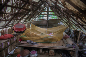 In one of the flood affected areas a man is sleeping in the temporarily built house made of bamboo and plastic sheet. Satkhira, Bangladesh