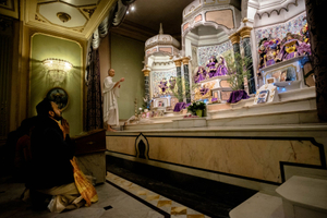 Devotees observe the evening temple ceremony - Gaura Arati