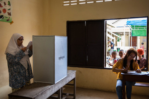 A Muslim woman casts her vote at her local Mosque on the outskirts of Phnom Penh.