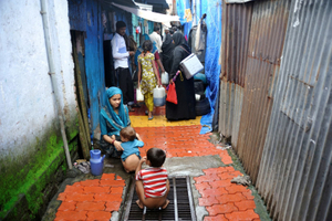 Polio vaccinators move around looking for children to vaccinate them, while children defecate on the streets ( one of the main reasons for polio virus ), Bhiwandi, Maharashtra