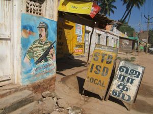 Fighter and telephone (STD) shop, vicinity Andippatti, between Madurai and Thekkady, Kerala, 2010.