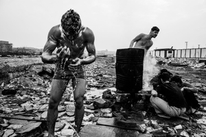 People wash themselves outside a makeshift shelter in Belgrade, Serbia.