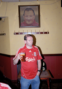 Liverpool Supporter in front of picture of Bill Shankley, Anfield, Liverpool 13 May 2007.