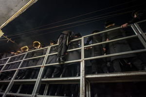 A yungerman climbs the packed bleachers to get a better view