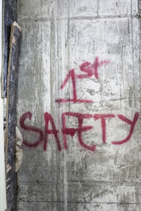 Spray painted sign on the wall of a construction site in central Phnom Penh.