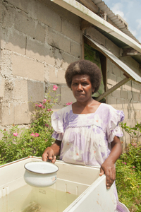 Jeannette Wallace, 47 years, storing water in her recycled freezer,  Paunagisu Village, Efate Island.