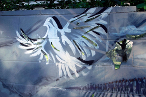 The wall, shown here with a mural of a bird, was intended to protect the adjoining white neighborhood from falling property values. Lenders would draw red lines on a map to mark areas with a high concentration of blacks, refusing to lend money in those areas.  Lenders used the political process to promote segregation. Under the 1934 National Housing Act, red-lining was legal. © Nicholas Gregory