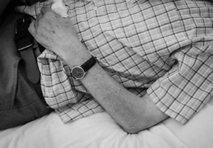 Taking time out to rest for a while on the bed in the care home as his temperature rises.