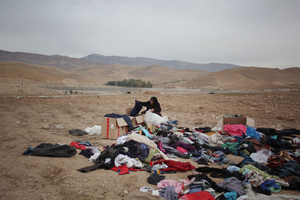 One of the villagers while choosing clothes from the clothing people threw away
