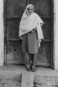 Old woman standing in front of her door  | Rurka, Punjab.