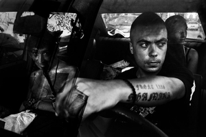 Kostas 24 his brother and sister sitting inside the car. Athens, Greece Enri Canaj