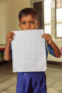 Boy holding class work