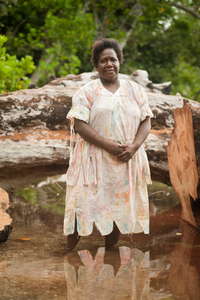 Carolyn Baba, 42 years, standing in front of a fallen tamarind tree, Meten Village, Efate Island.