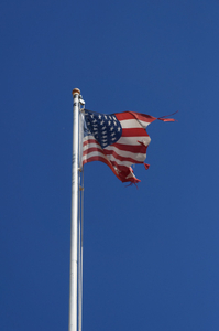 Torn by high winds American flag