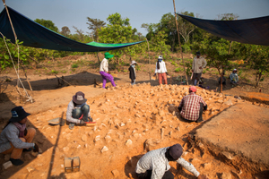 A group of workers carefully remove dust to uncover what could have been the basis of a Pre-Angkorian temple during an excavation at Phnom Kulen by the ADF team. Siem Reap Province, Cambodia.