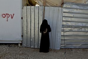 A woman opening the front porch of her container home. © Tom Verbruggen