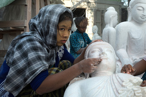 Labourer polishes a statue of Buddha, Mandalay, Myanmar.