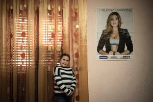 Elena Alvetta, 8 years old, poses inside her room. She is a great fan of Emiliana Cantone.