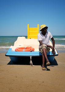 Resting beach vendor (not aware of his spontaneous model attitude)