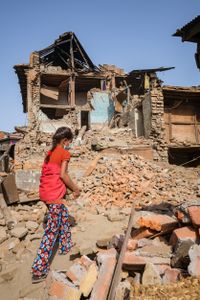 Eight year old Yamuna helps to clear rubble from the remains of her family home, destroyed by the 2015 Nepal earthquake.