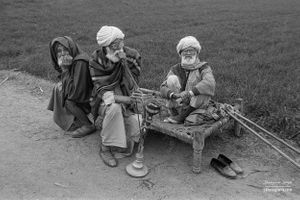 Three friends passing time by the side of a road | Dhanda, Punjab.