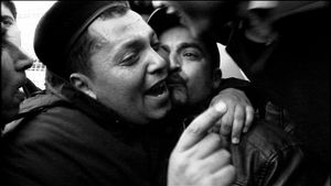 Tunis, Tunisia (2011). A policeman, who just decided to join protesters, is hugged and kissed by the crowd.