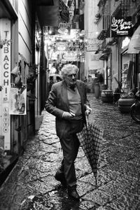 The man with the checkered umbrella