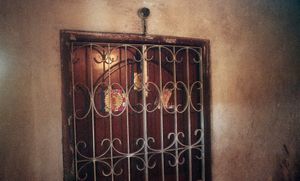 Yangon, Myanmar, 2013. The doorway to a 969 supporter's house. In areas of town where ethnicities are mixed, families use flags and stickers outside their houses to determine they're affiliation, and iron bars for safety. © Spike Johnson