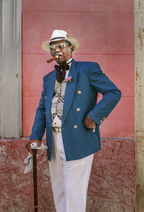 A Cuban man make his profession by dressing up in colonial clothes for business on the Plaza de la Catedral in old Havana.