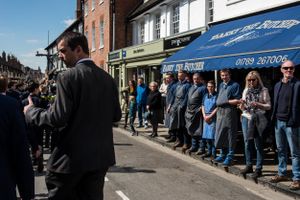 The local butchers watch the parade make it's way through the town.
