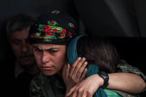 During a ceremony in Kobane, Syria, on 2 April, 2015, mourners gather by the coffin of their loved ones who were killed during clashes with the Islamic State in one of the frontlines of Kobane, Syria.
