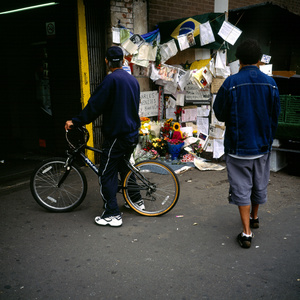 Mourners at the corner of Stockwell Tube station in London the day after the fatal shooting by police of Jean Charles de Menezes suspected of being a terrorist bomber later found to be a case of mistaken identity.
