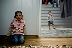 Two children posing in their container home. © Tom Verbruggen