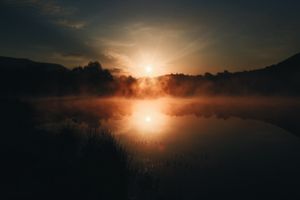 Sun rises in the lake and sky
