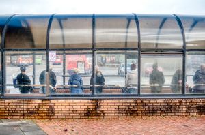 3 Passengers wait for their bus
