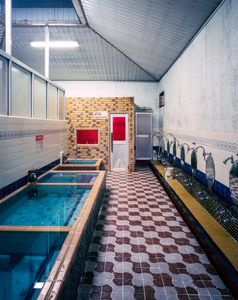 Local public bath / Tokiwayu :Red sauna window and long bath in the back
