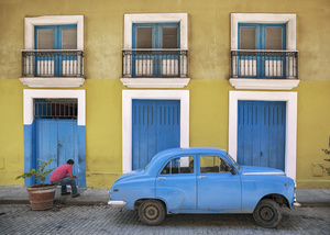 A blue 1954 Morris Crowley is parked in front of a colonial facade in La Habana Vieja the old part of Havana.