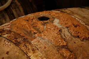 Impurities escape from an open hole in a barrel as apple juice slowly turns into cider