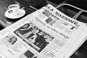 Traditional newspaper reader in Antico Caffé Poliziano