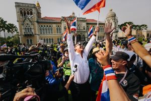 Controversial Thai politician Chuwit Kamolvisit celebrating with anti-Government protesters in front of Government House in Bangkok, Thailand. Police removed barriers preventing access to the Government complex following a week of violent clashes.