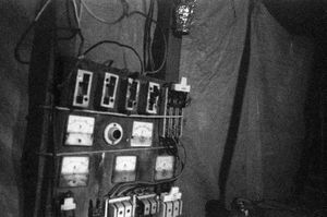 Sintku Township, Mandalay Division, Myanmar, 2013. A winch control panel, with radio to communicate with the miners. As the controller hoists the workers to the requested height, the electrical contacts spark in the darkness. © Spike Johnson