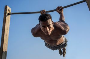 El Puche, Almeria, Spain. Young African immigrant practices street workout.