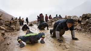 A group of young Tibetan men from Litang crosses the 5,000 metre Dongda Pass on the former tea Horse Road to Lhasa, body-length at a time on their several-month pilgrimage. © Michael Freeman