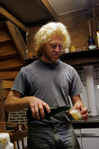 Laurent Delaporte pours a glass of cider that he makes using artisanal methods on his father's farm