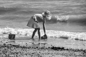 Blonde girl playing by the seaside, Clacton-on-Sea