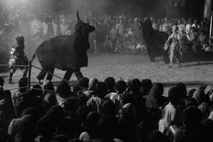 Chhau dancers, in black suits resembling animals