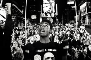 Young man, backed by a roaring crowd, cheers on as Obama takes on another state, moments before winning the election.Times Square, November 2008© Enilffo Raeppa