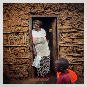 A woman stands in the doorway of her wattle and daub house in Kibera. The Kibera slum is the largest slum in Nairobi with around half a million inhabitants.