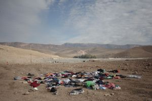 Unusable clothes which were thrown out by the victims of earthquake . The reason for this action is that the local people often wear regional clothing which is specific to their culture and they avoid wearing fashionable clothes